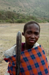 Young cattle herder near a remote lake on the Serengeti, Africa